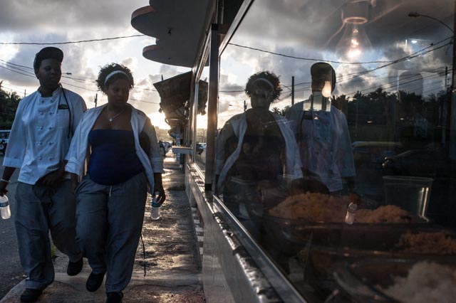 A couple heads home from working at a food vendor strip mall near Luquillo, Puerto Rico